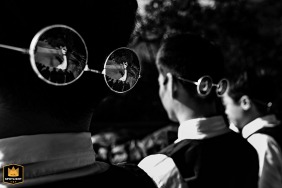 In a hotel in Fujian, China, the bride and groom share a kiss, perfectly reflected in the best man's sunglasses, captured in a black and white image that emphasizes the playful and creative perspective of the wedding day.